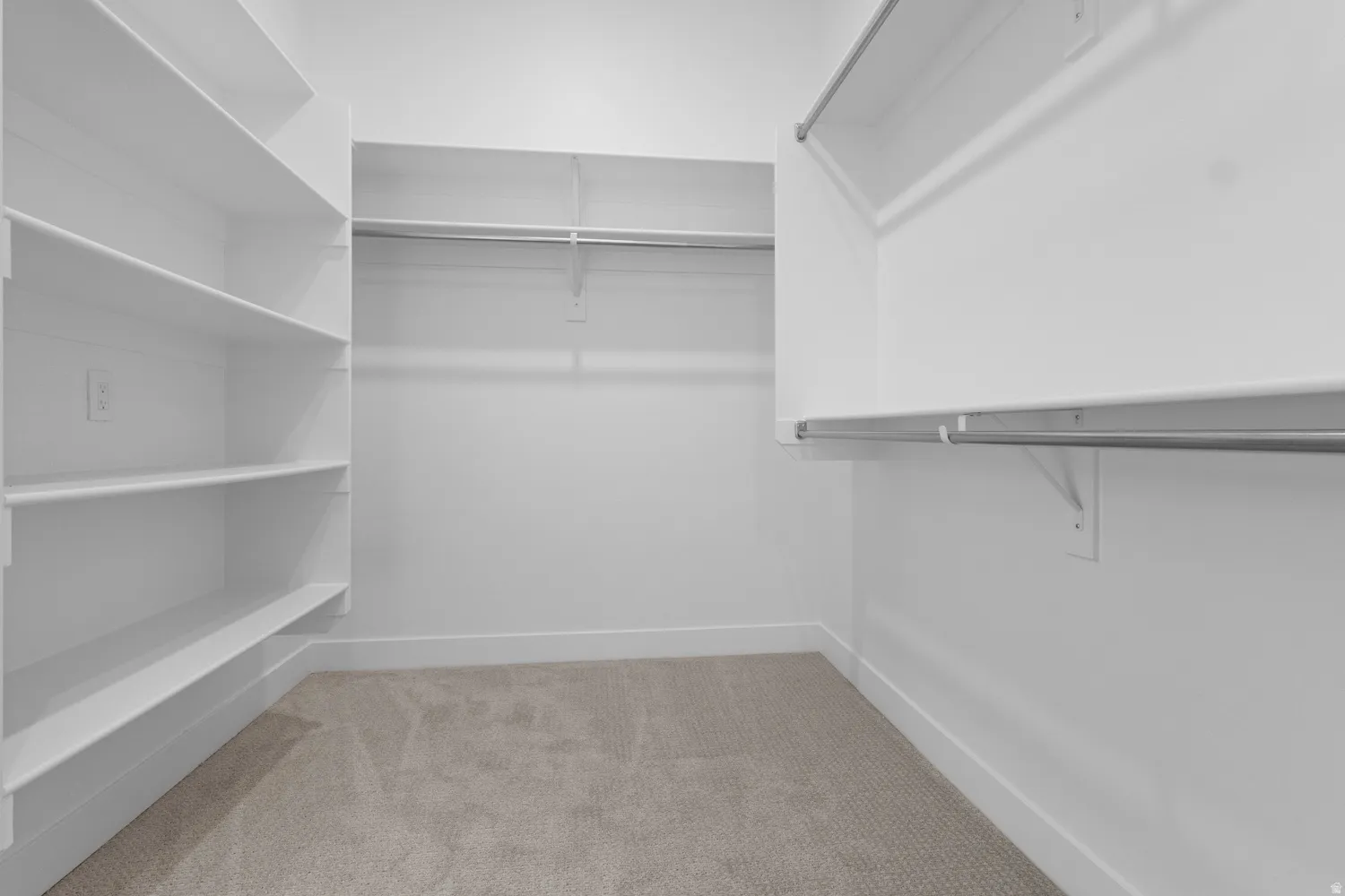 Walk in closet with light carpet