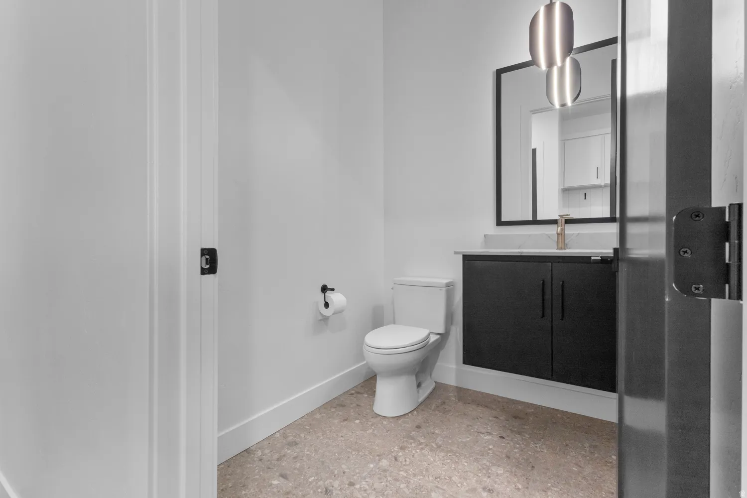Half bathroom featuring baseboards and vanity
