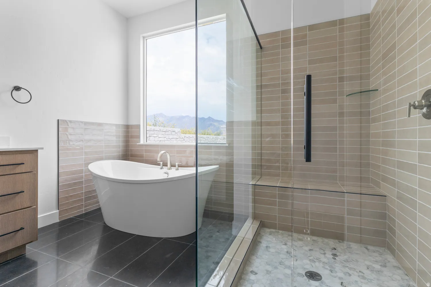 Full bath featuring a soaking tub, tile walls, vanity, a stall shower, and tile patterned flooring