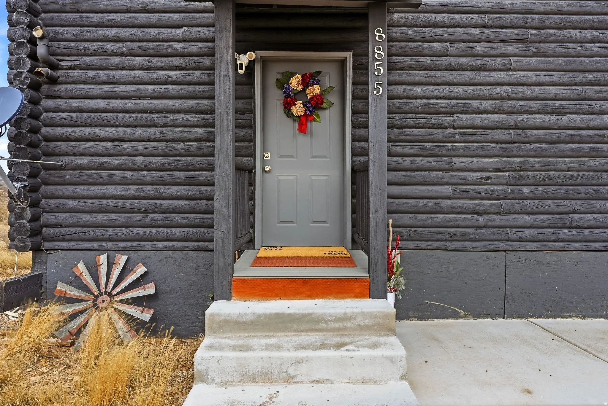 Property entrance with log siding