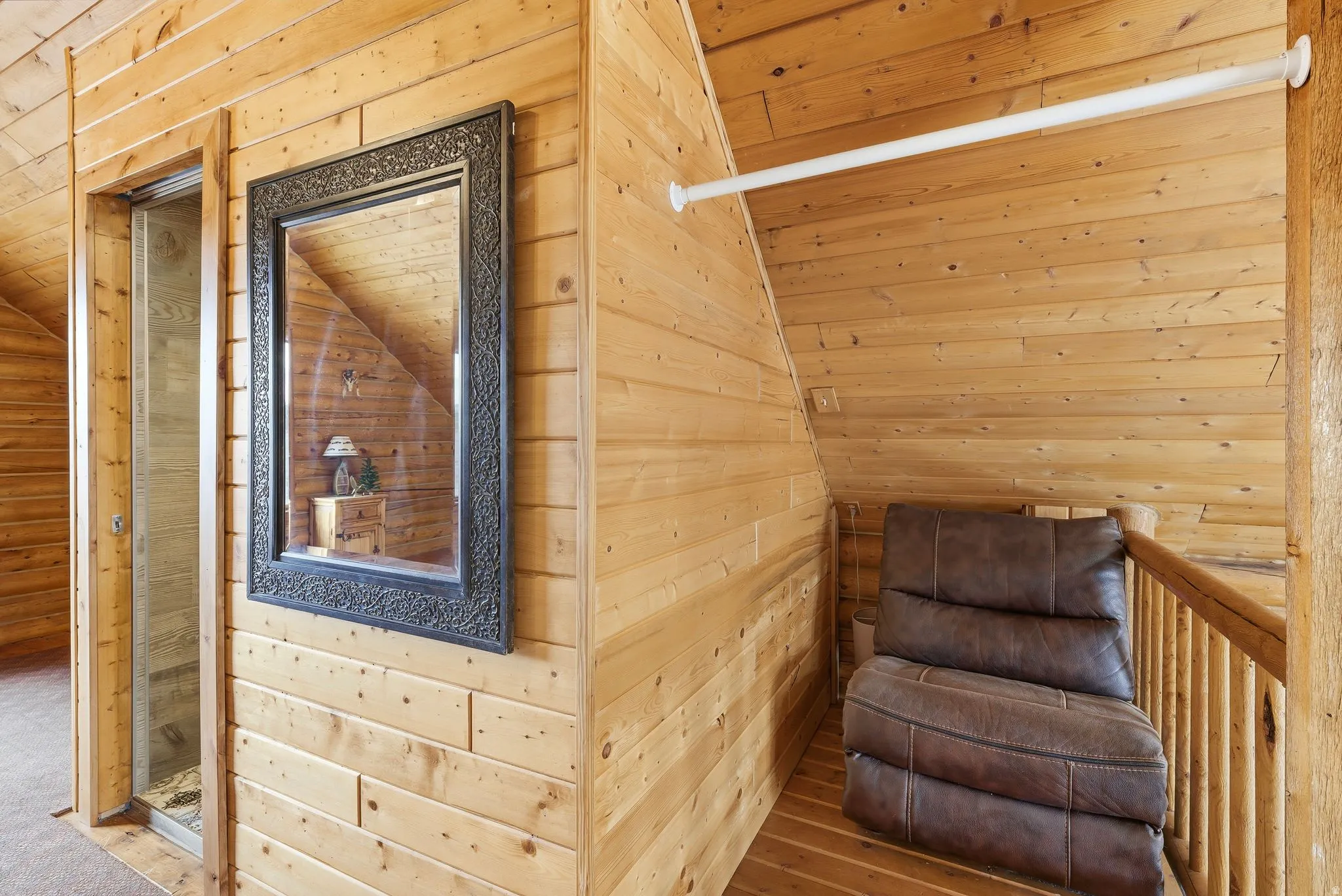 Living area featuring wooden walls and a vaulted wood ceiling