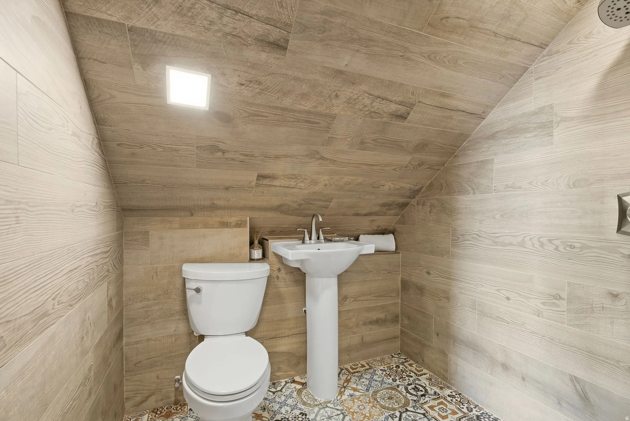 Half bath with vaulted ceiling and toilet