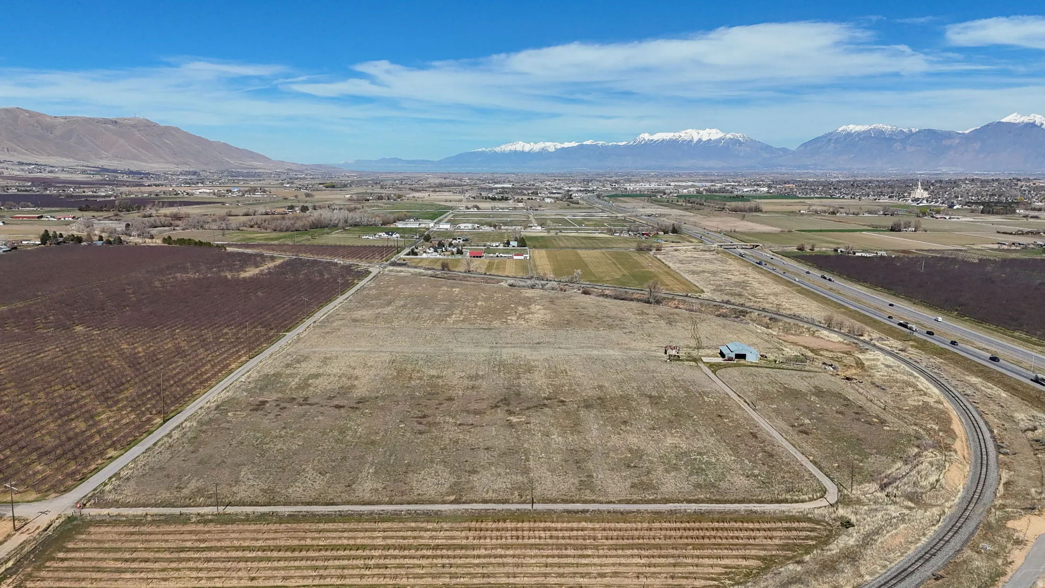 Overview of rural landscape with farmland and a mountainous background