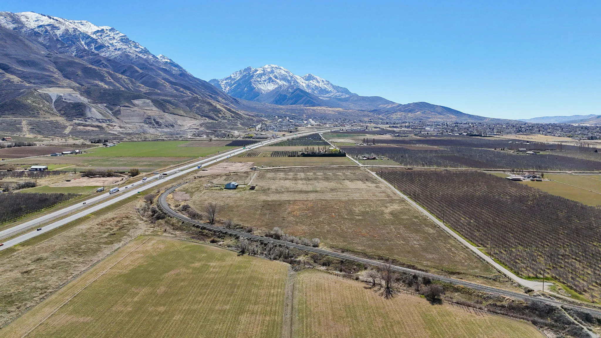 Overview of rural landscape with abundant farmland and a mountain backdrop