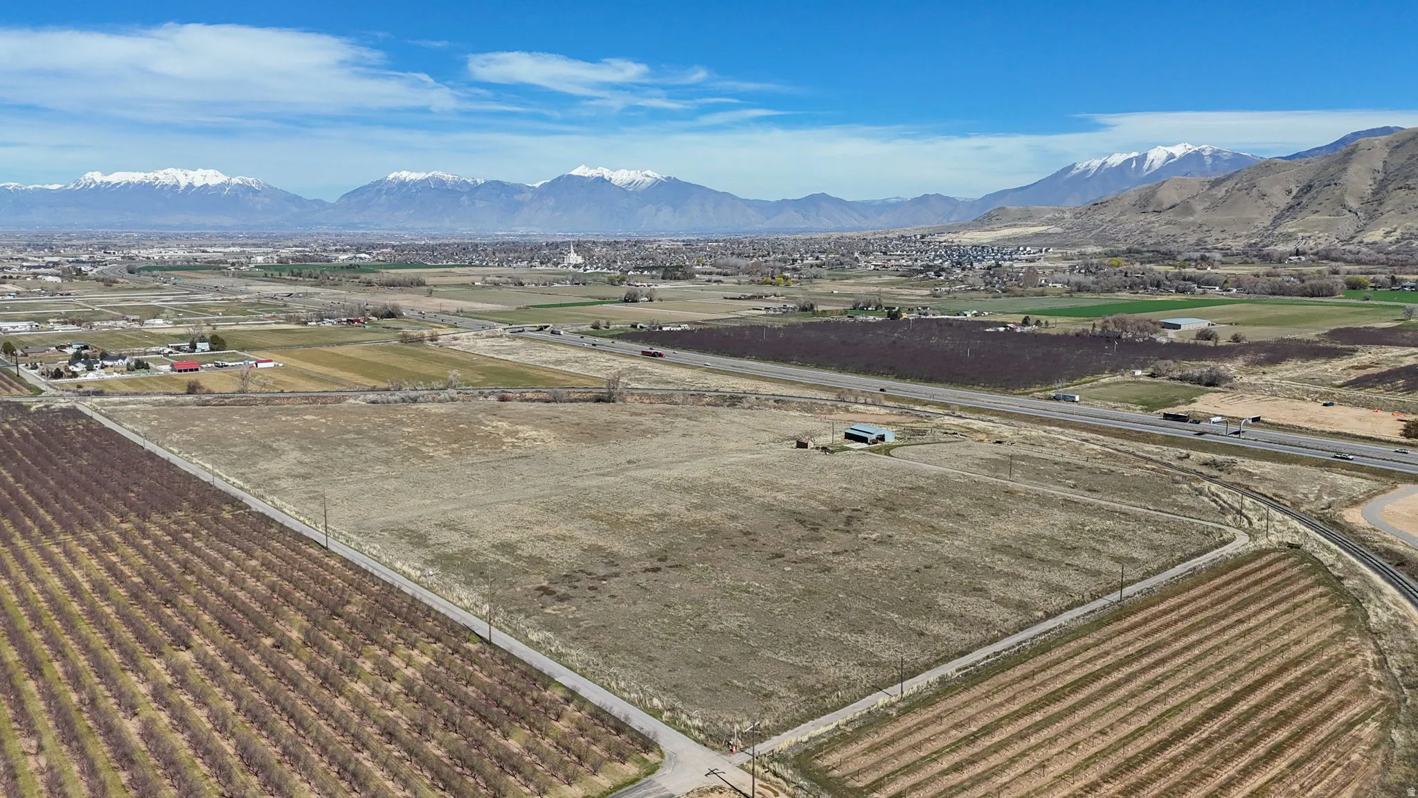 Overview of rural landscape featuring abundant farmland and a mountain backdrop