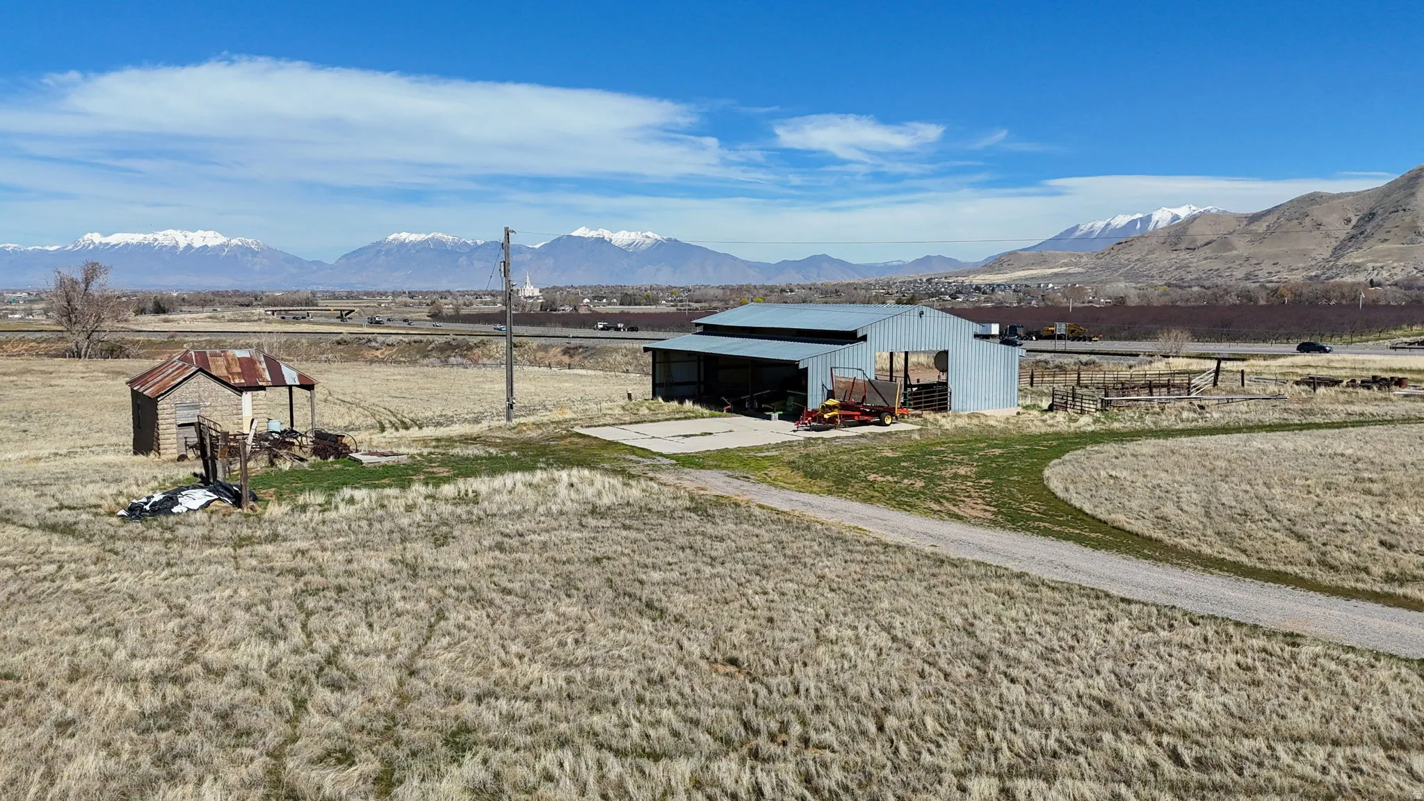 View of yard with an outbuilding, a pole building, a mountain view, a sunroom, and a rural view