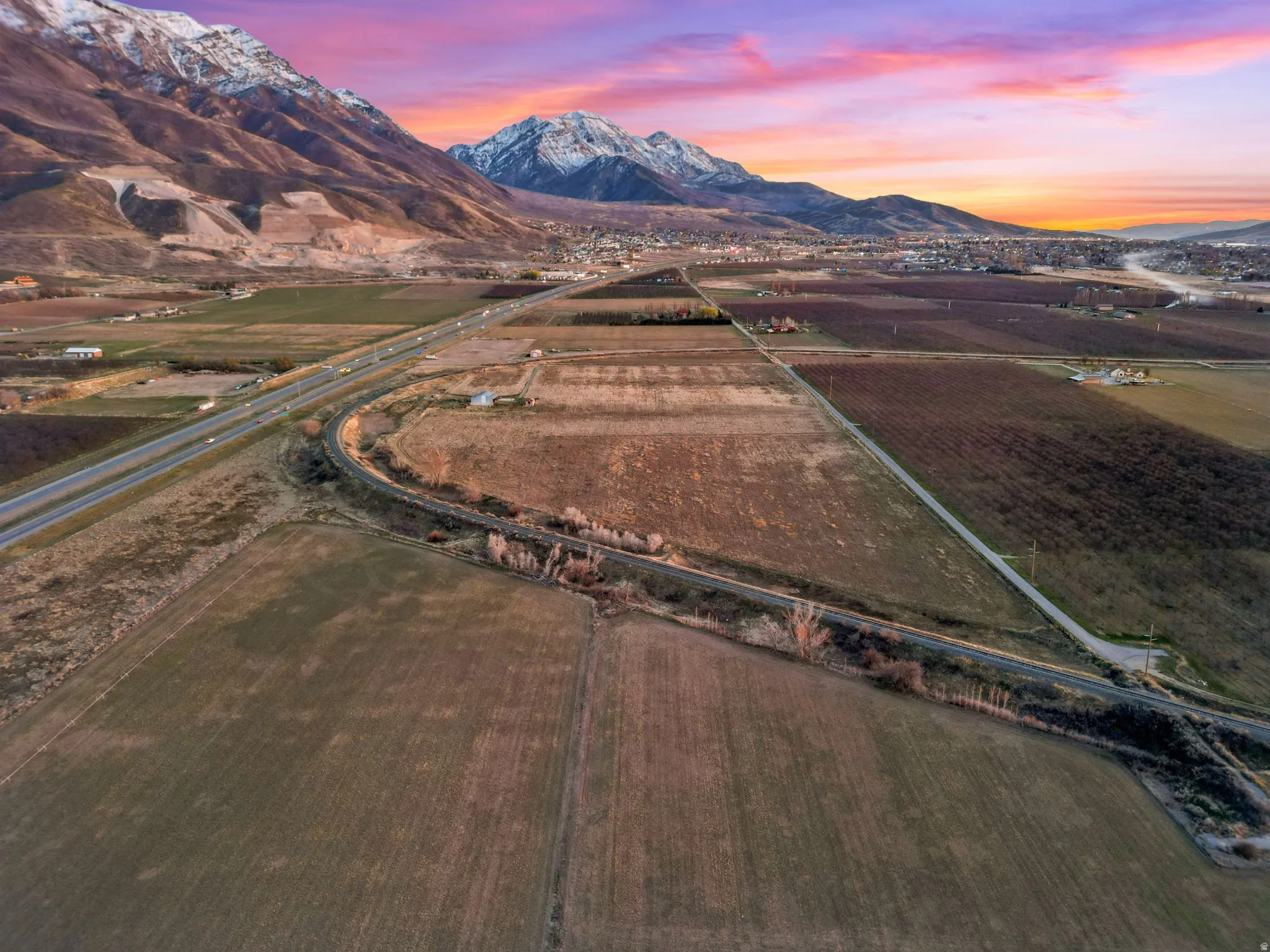 Aerial view at dusk of a view of rural / pastoral area, a mountain view, and agricultural area