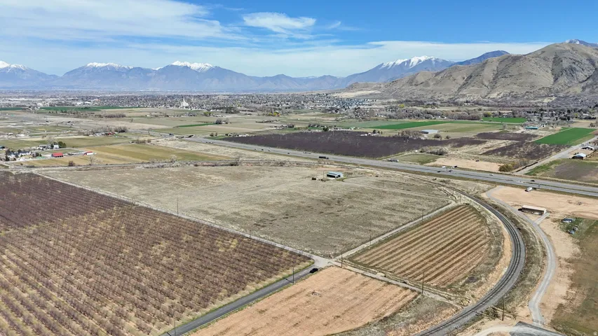 Aerial view of sparsely populated area with mountains and extensive farmland