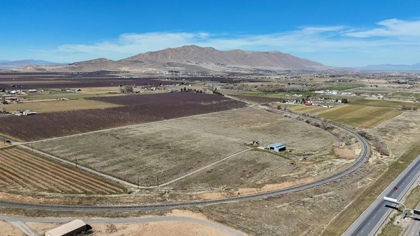 Aerial view of sparsely populated area featuring abundant farmland and a mountainous background
