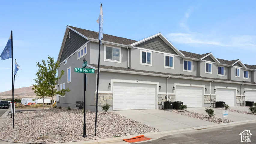 Contemporary multi-story exterior with light gray stucco and dark gray siding accents