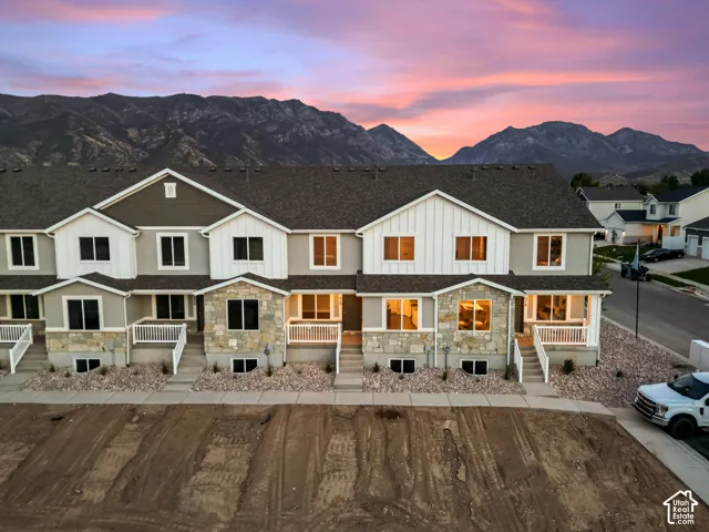 Modern townhome exteriors featuring varied siding, stone accents, and white trim