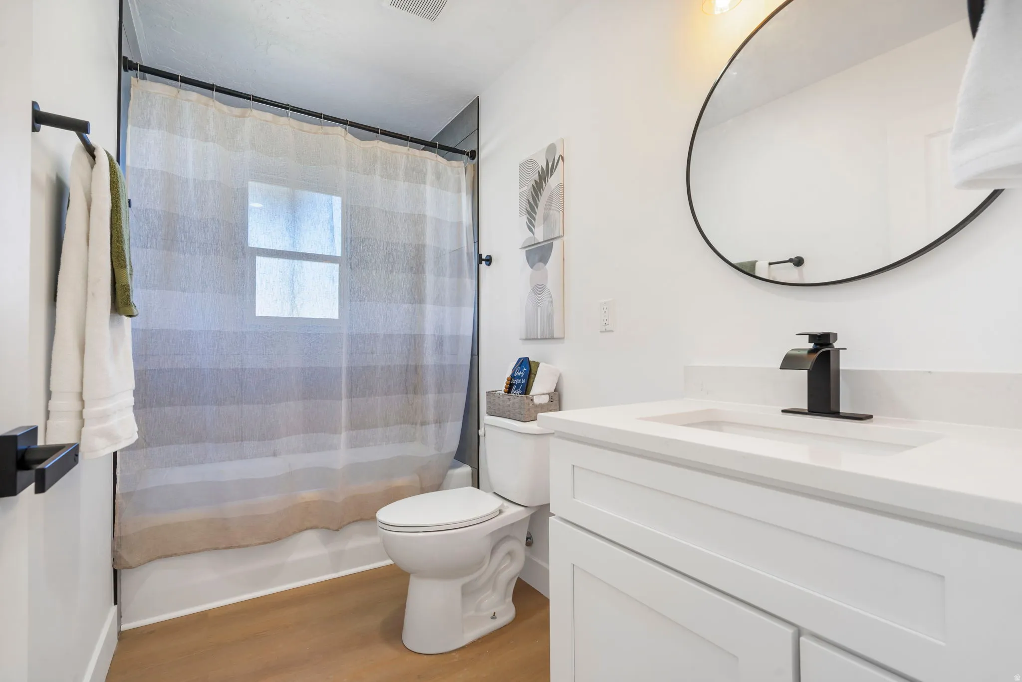 Full bath featuring vanity and light wood-style flooring