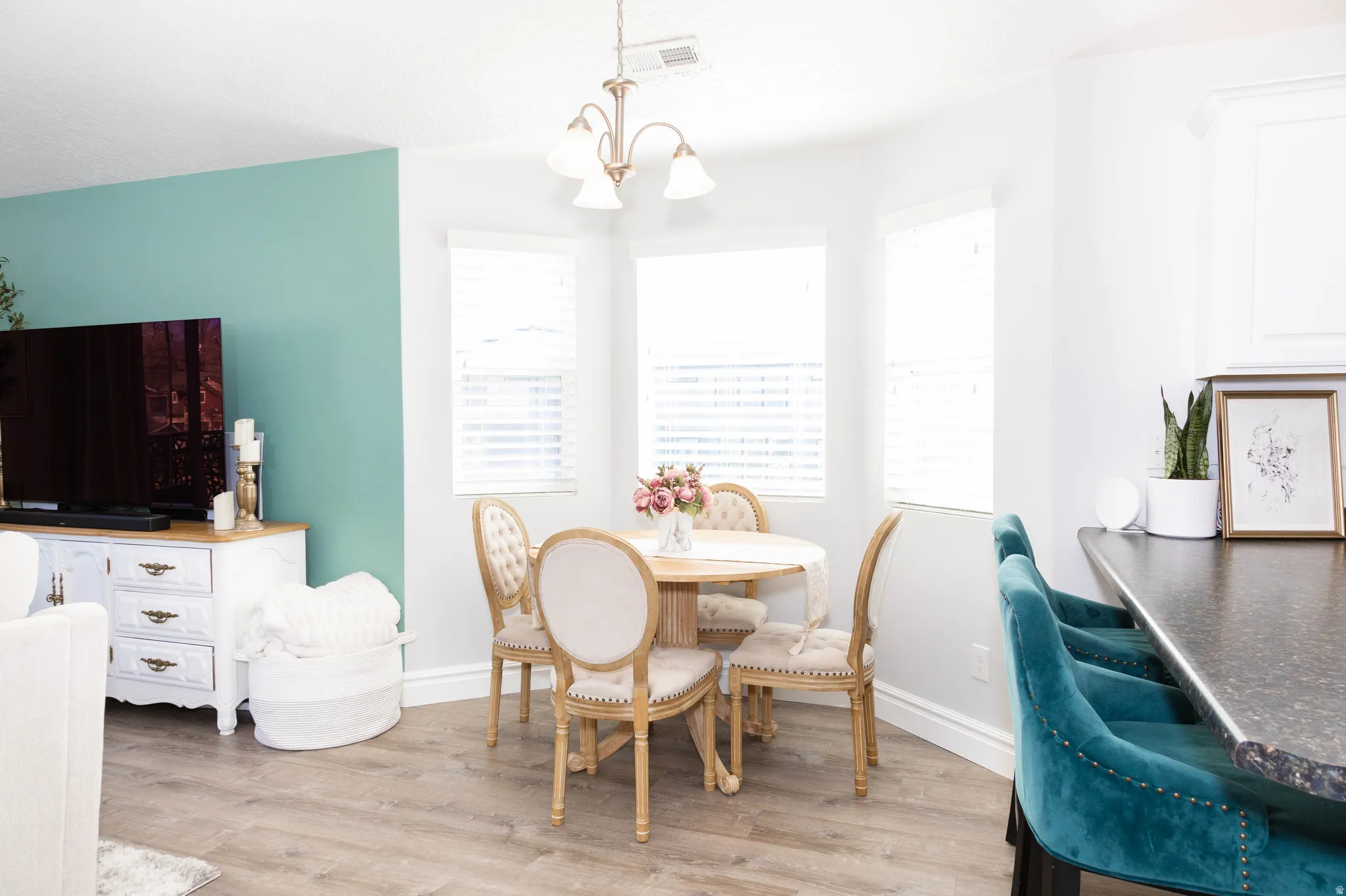 Dining area featuring light wood finished floors and hanging lights