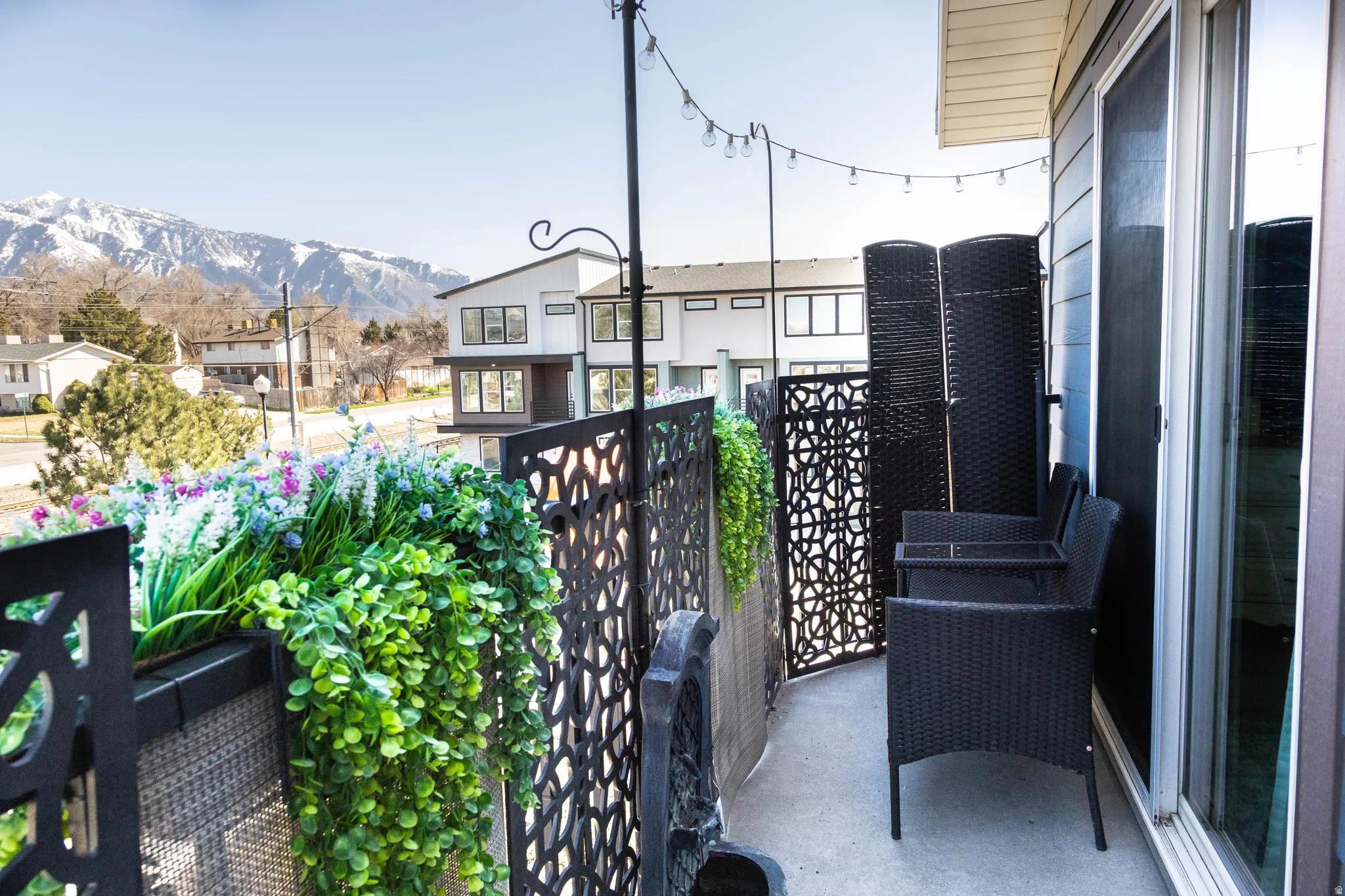 Balcony featuring a residential view and a mountain view
