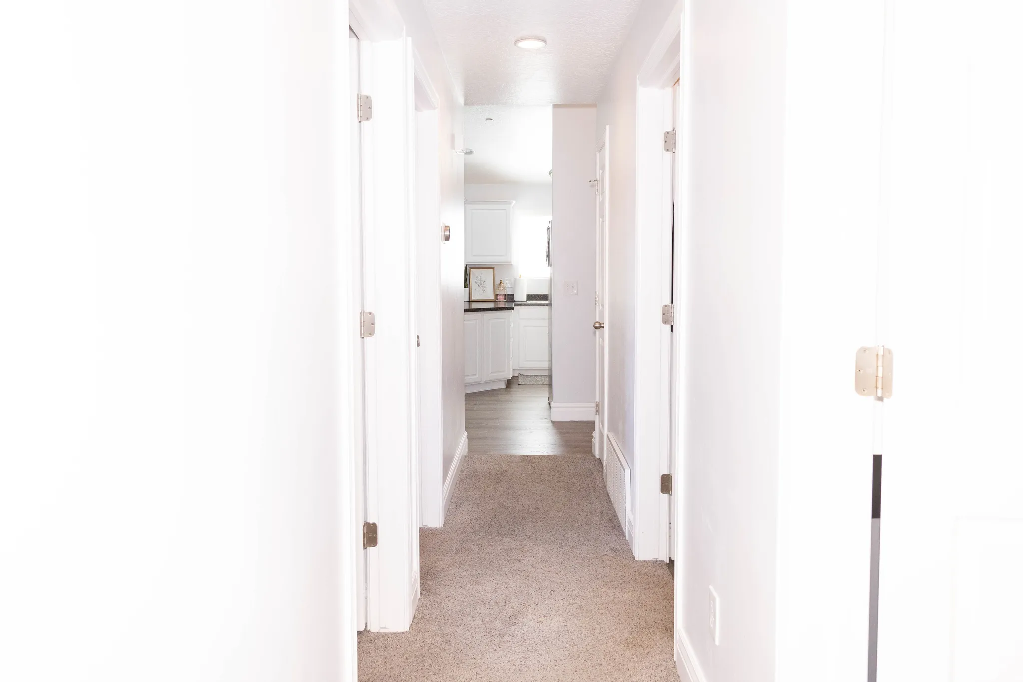 Hallway featuring light carpet and recessed lighting