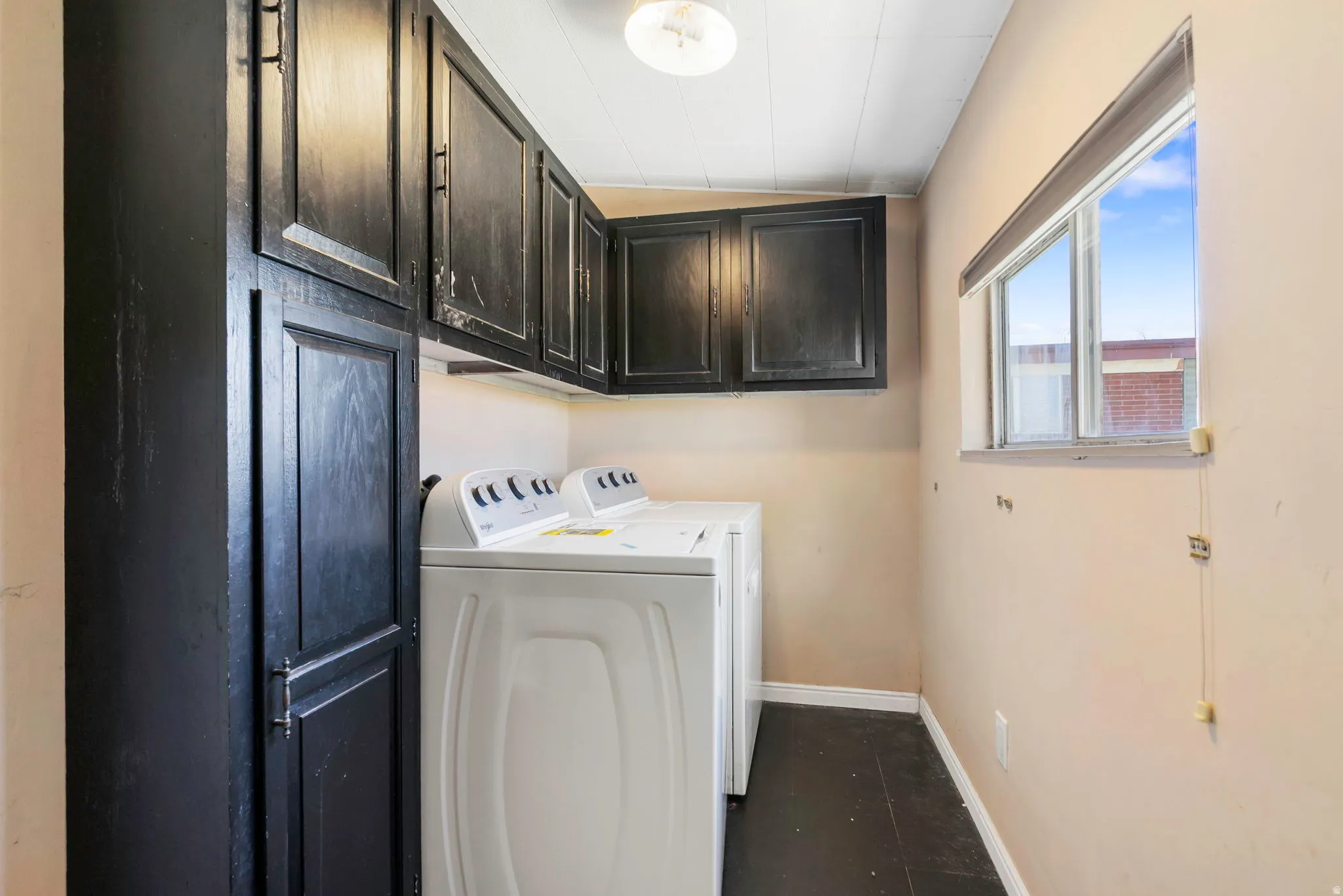 Laundry area featuring cabinet space and washer and clothes dryer