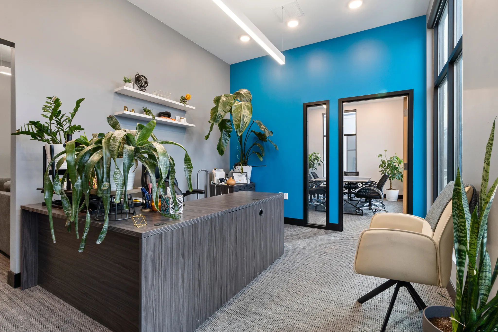 Office with light colored carpet and baseboards