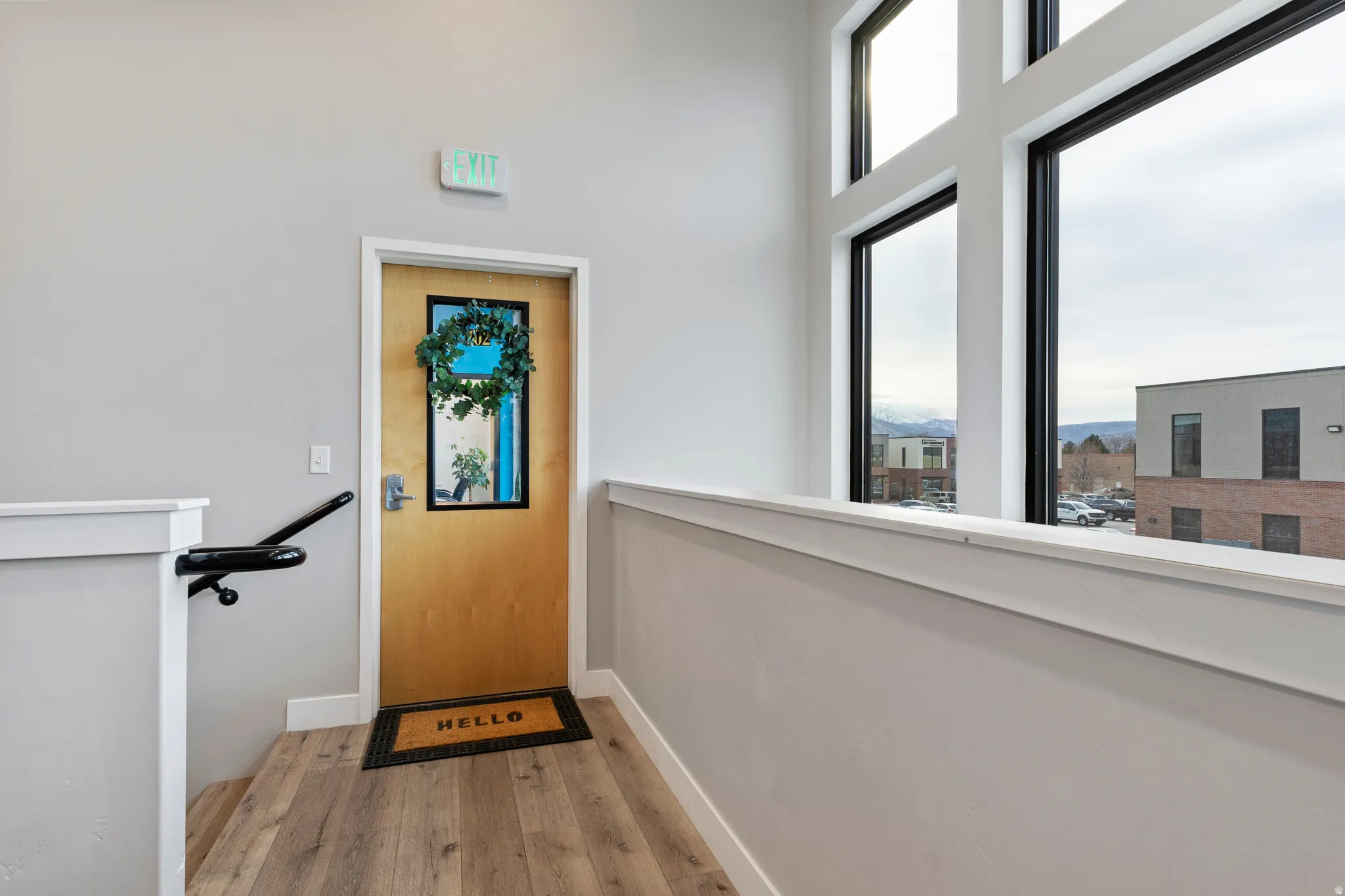 Doorway with wood finished floors and healthy amount of natural light