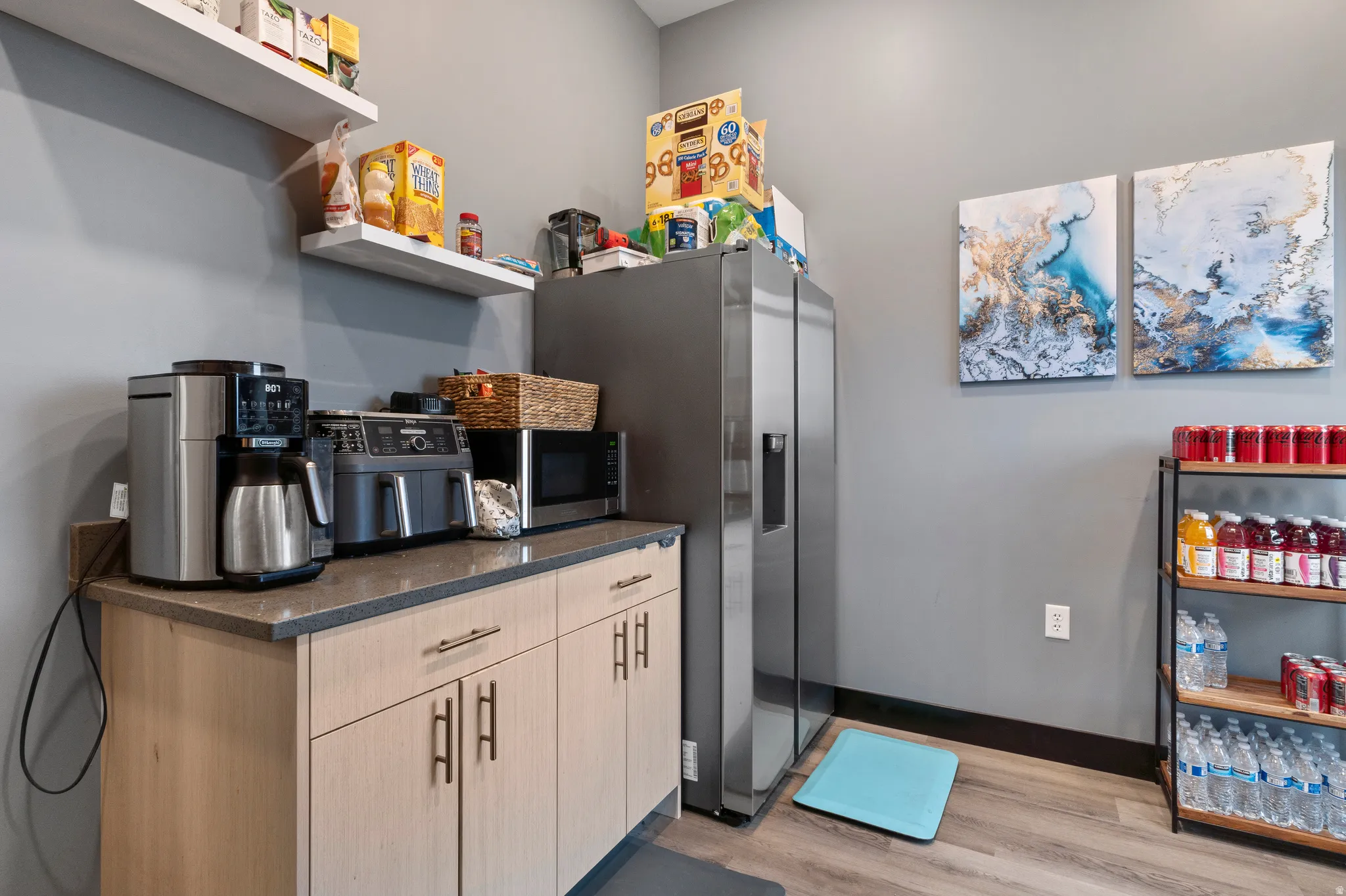 Kitchen featuring light wood finished floors, stainless steel appliances, and light wood finish cabinets