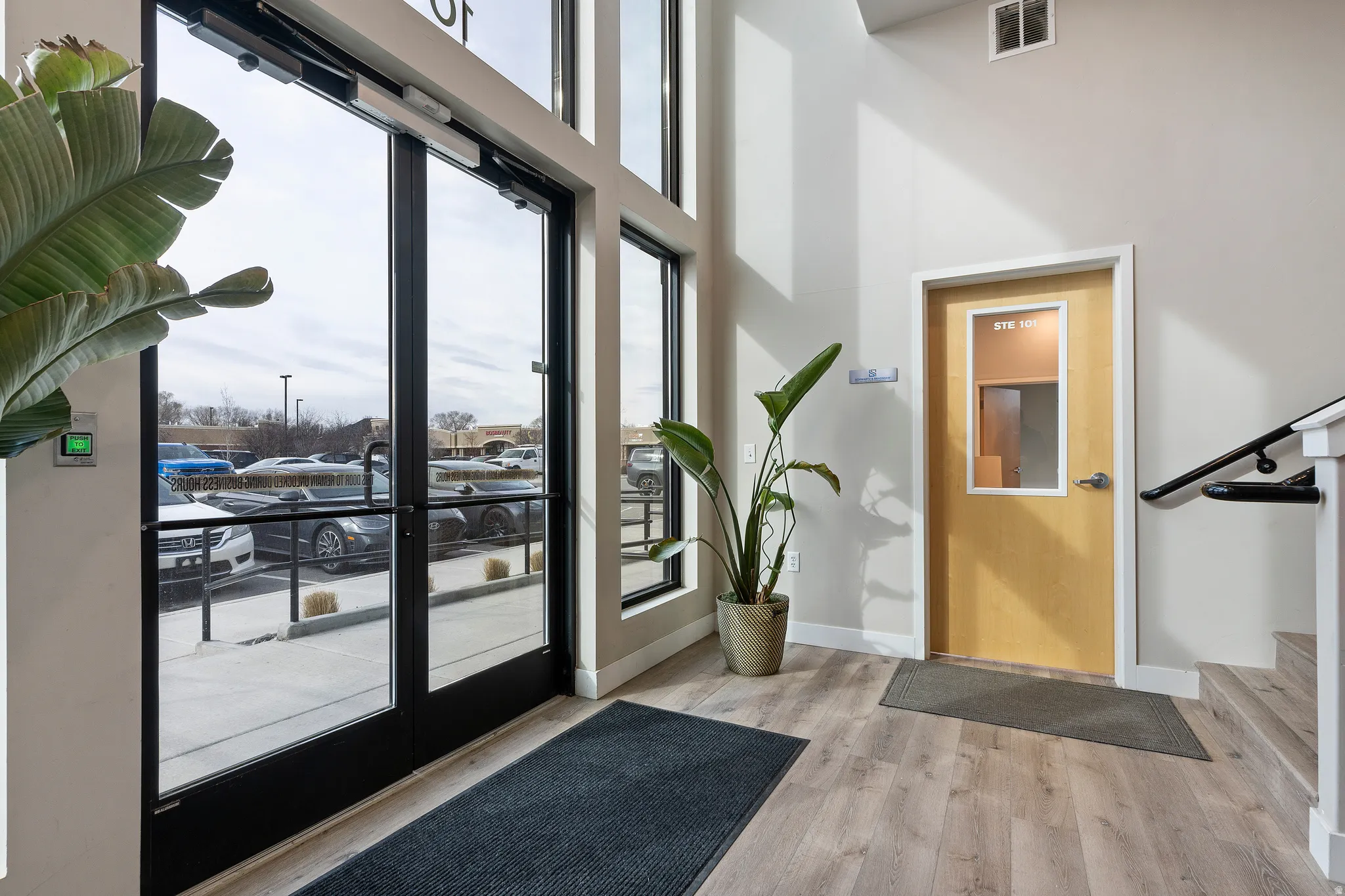 Foyer entrance featuring light wood-type flooring and a high ceiling