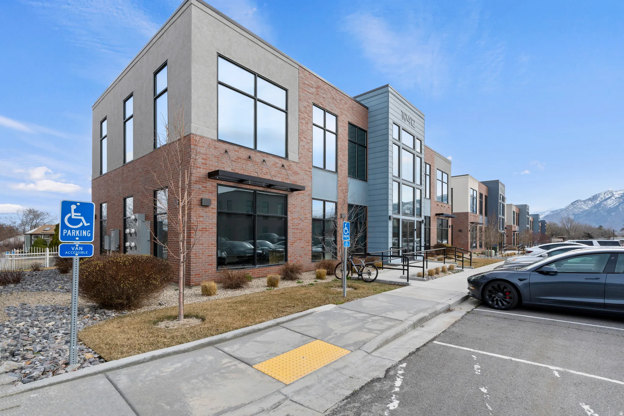 View of building exterior with uncovered parking and a mountain view