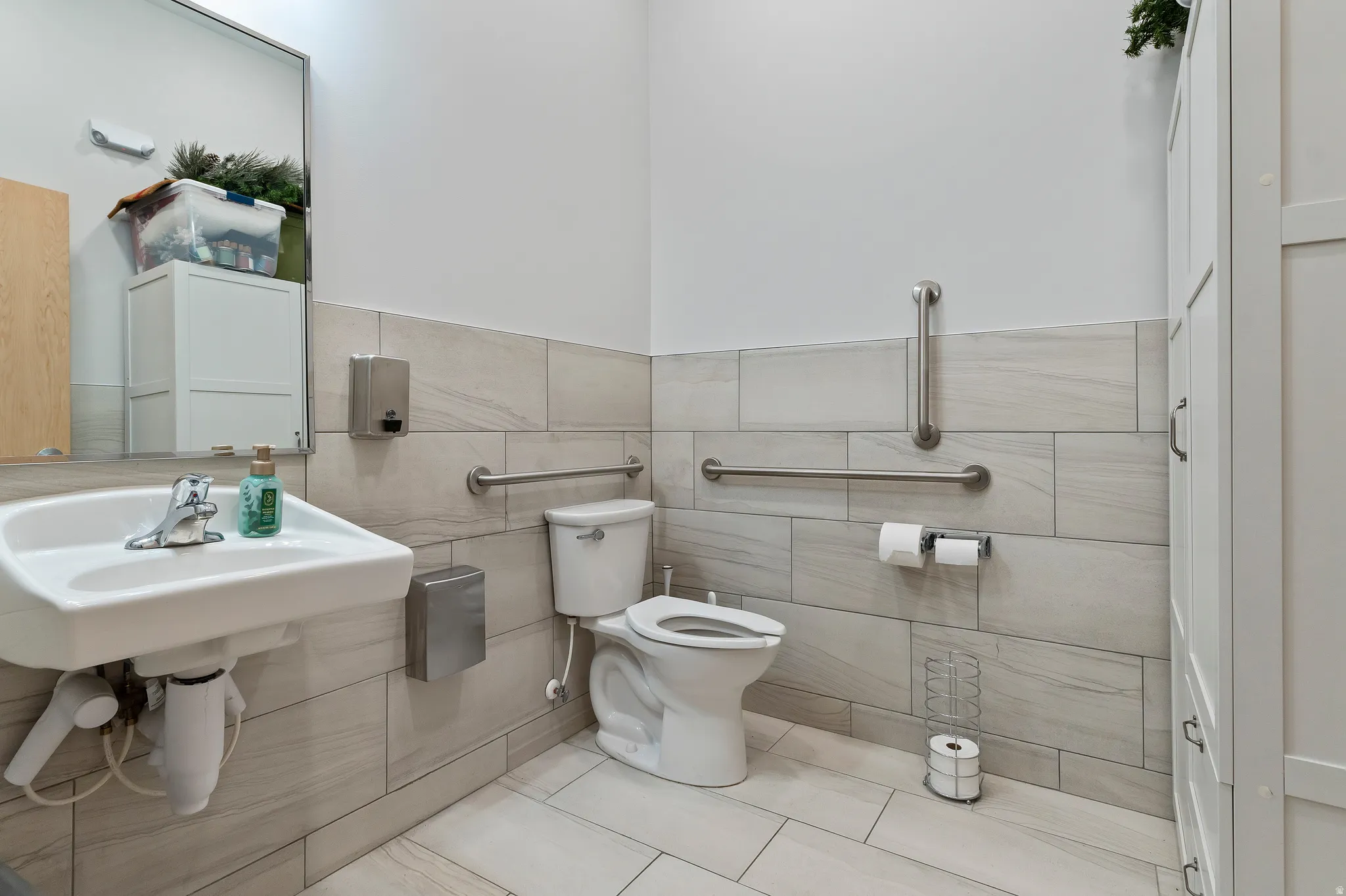 Bathroom featuring tile walls and light tile patterned floors