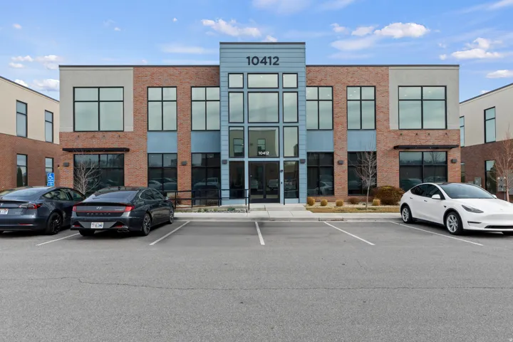 View of property with uncovered parking