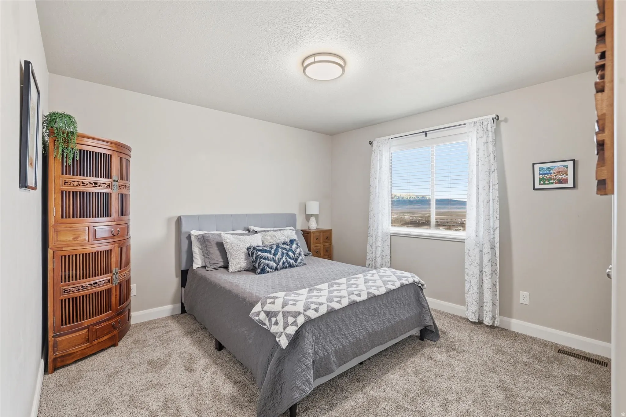 Bedroom featuring light carpet