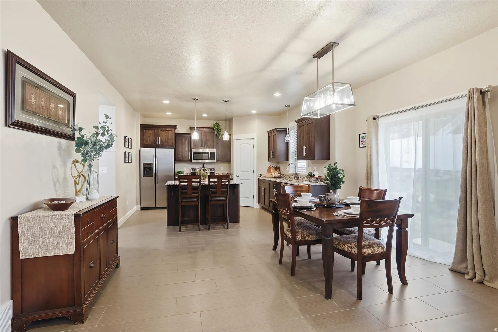 Dining space with recessed lighting and baseboards