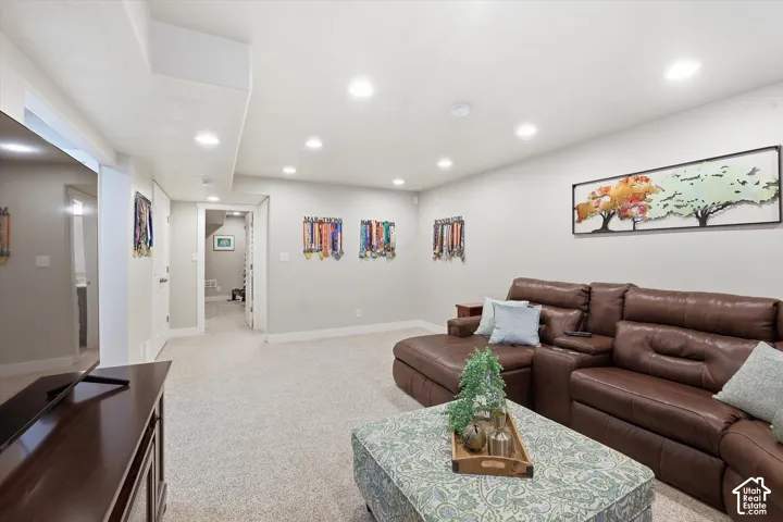 Living area featuring light carpet and recessed lighting