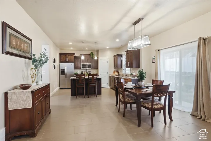 Dining space with recessed lighting and baseboards