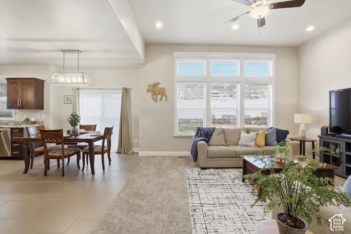 Living room with ceiling fan, recessed lighting, and light tile patterned flooring