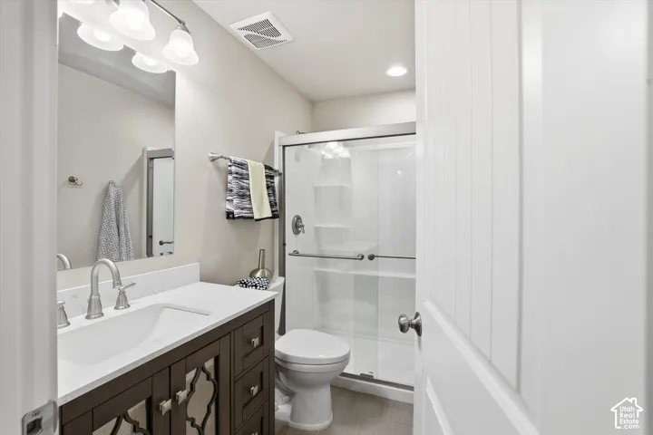Bathroom featuring vanity, a shower stall, and recessed lighting