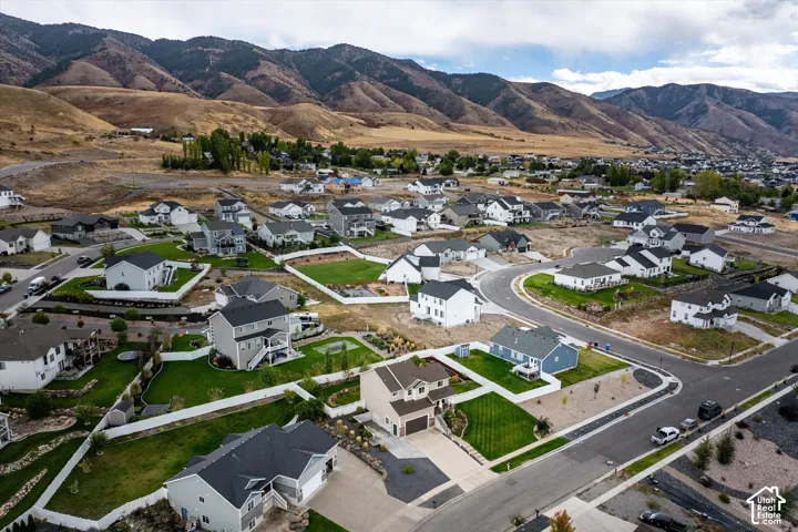 Aerial view of property's location featuring a mountain backdrop and nearby suburban area