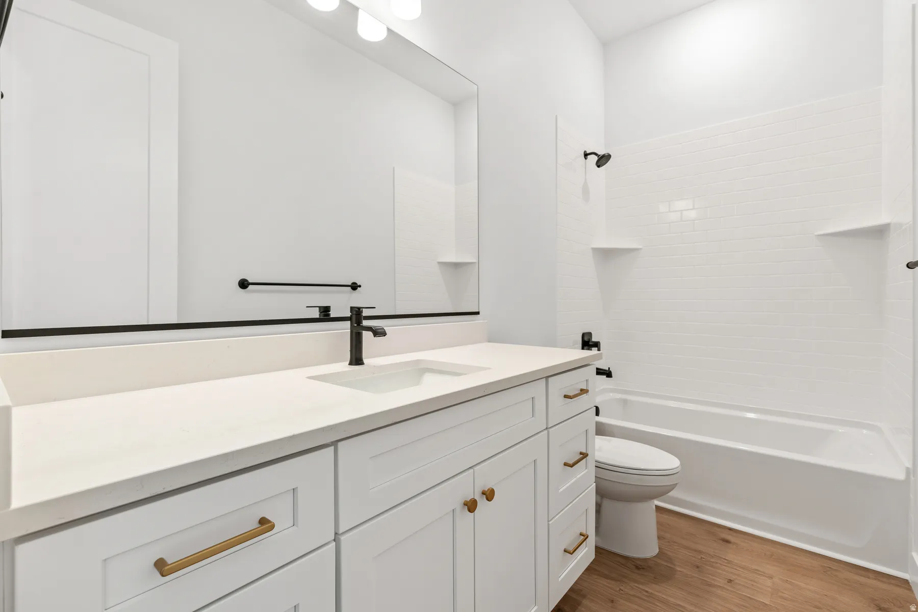 Full bathroom featuring vanity, light wood-style flooring, and tub / shower combination