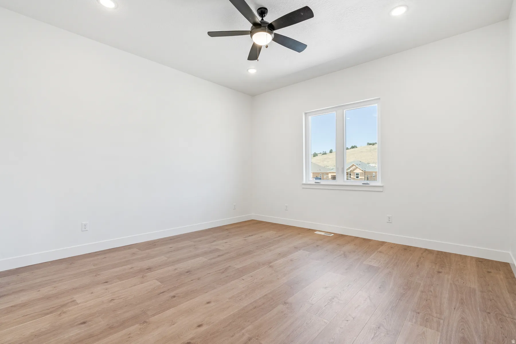 Empty room featuring recessed lighting, light wood-type flooring, and ceiling fan