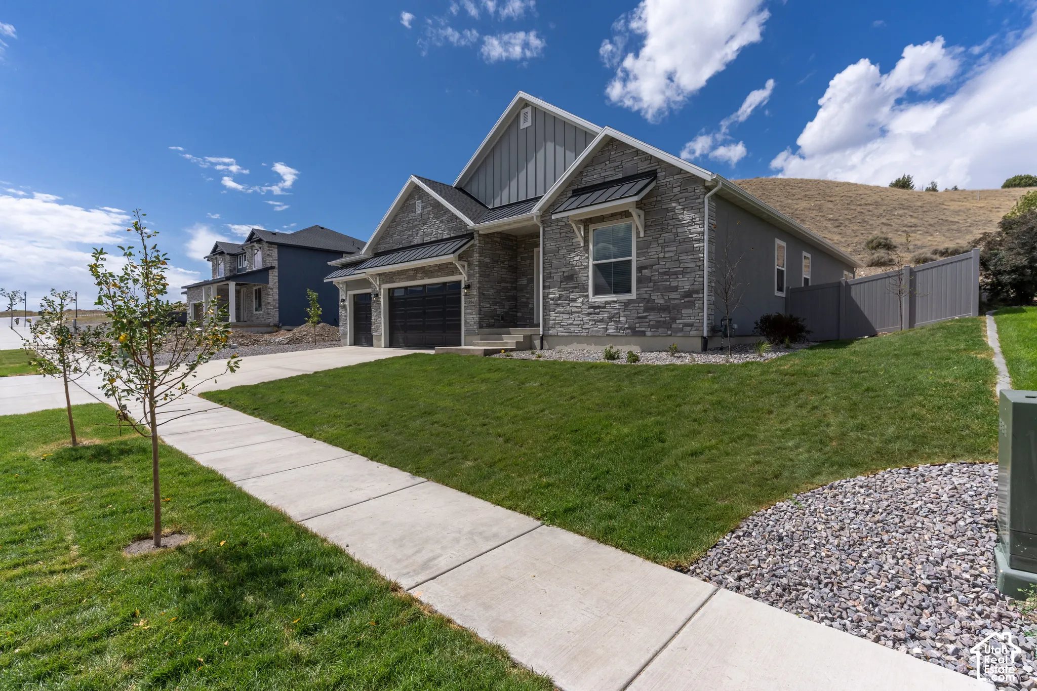 Contemporary exterior featuring stone veneer and vertical siding accents