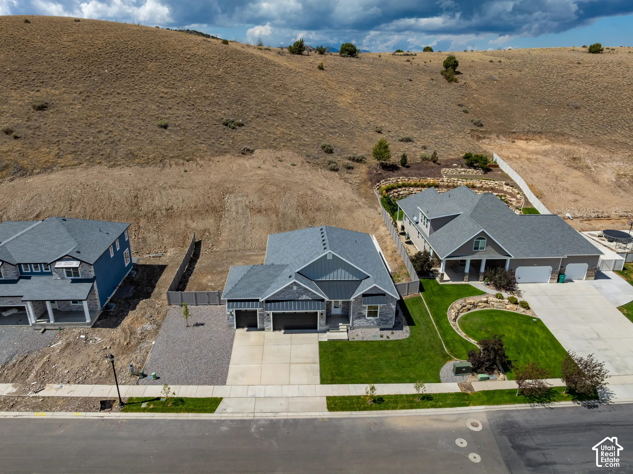 Modern residence featuring a gray exterior, attached two-car garage, and a concrete driveway
