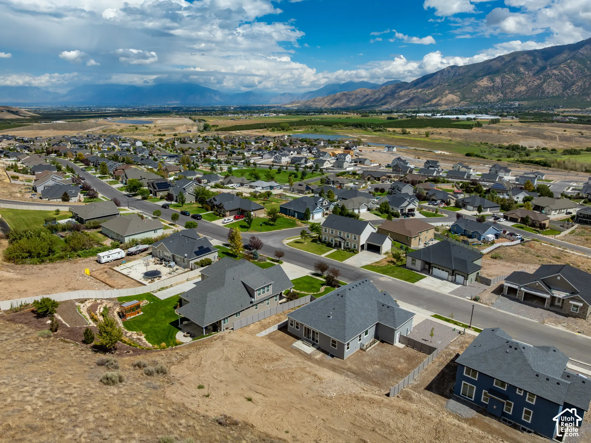 Expansive residential development with mountain scenery and distant water features