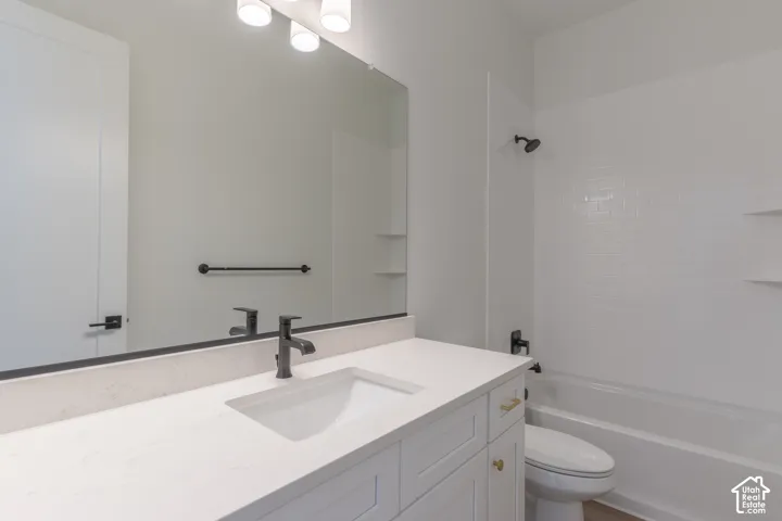 Vanity with an integrated sink, matte black faucet, and light-toned countertop