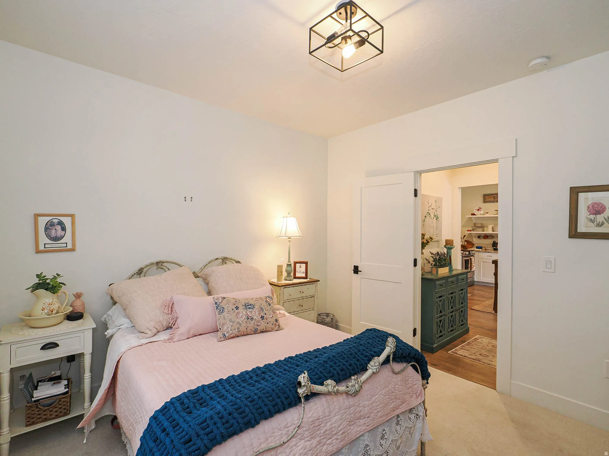 Bedroom featuring light carpet and baseboards