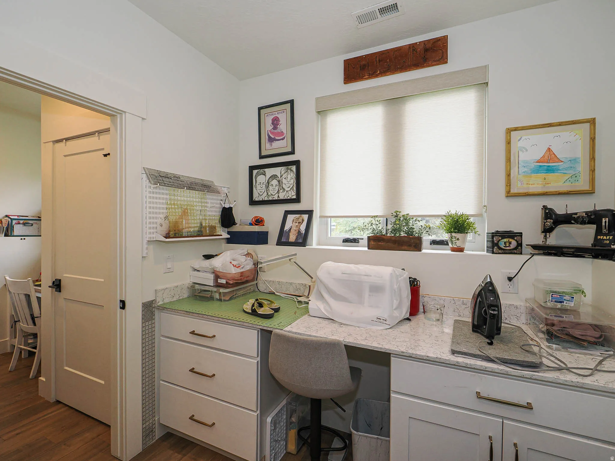 Office with dark wood-style floors and built in study area