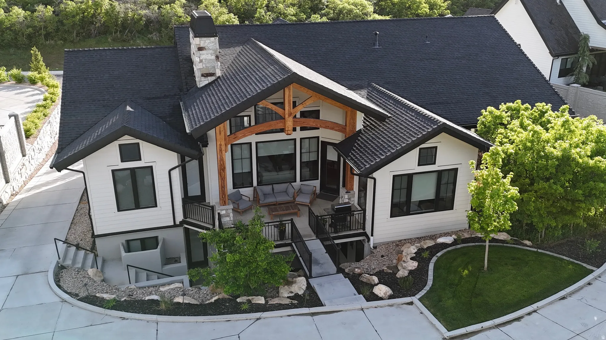 Back of property featuring a chimney and stairway