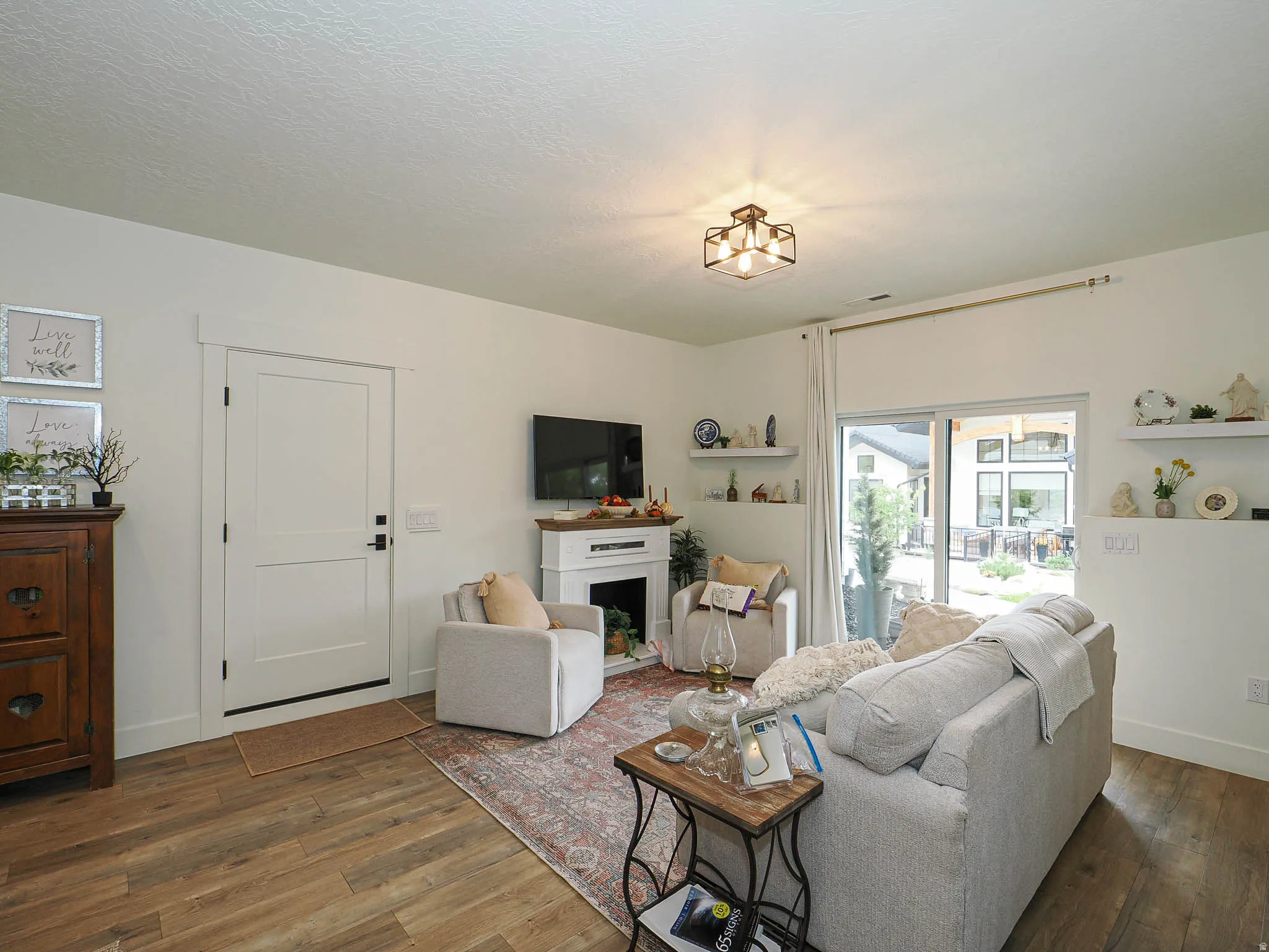 Living room with wood-type flooring and a fireplace