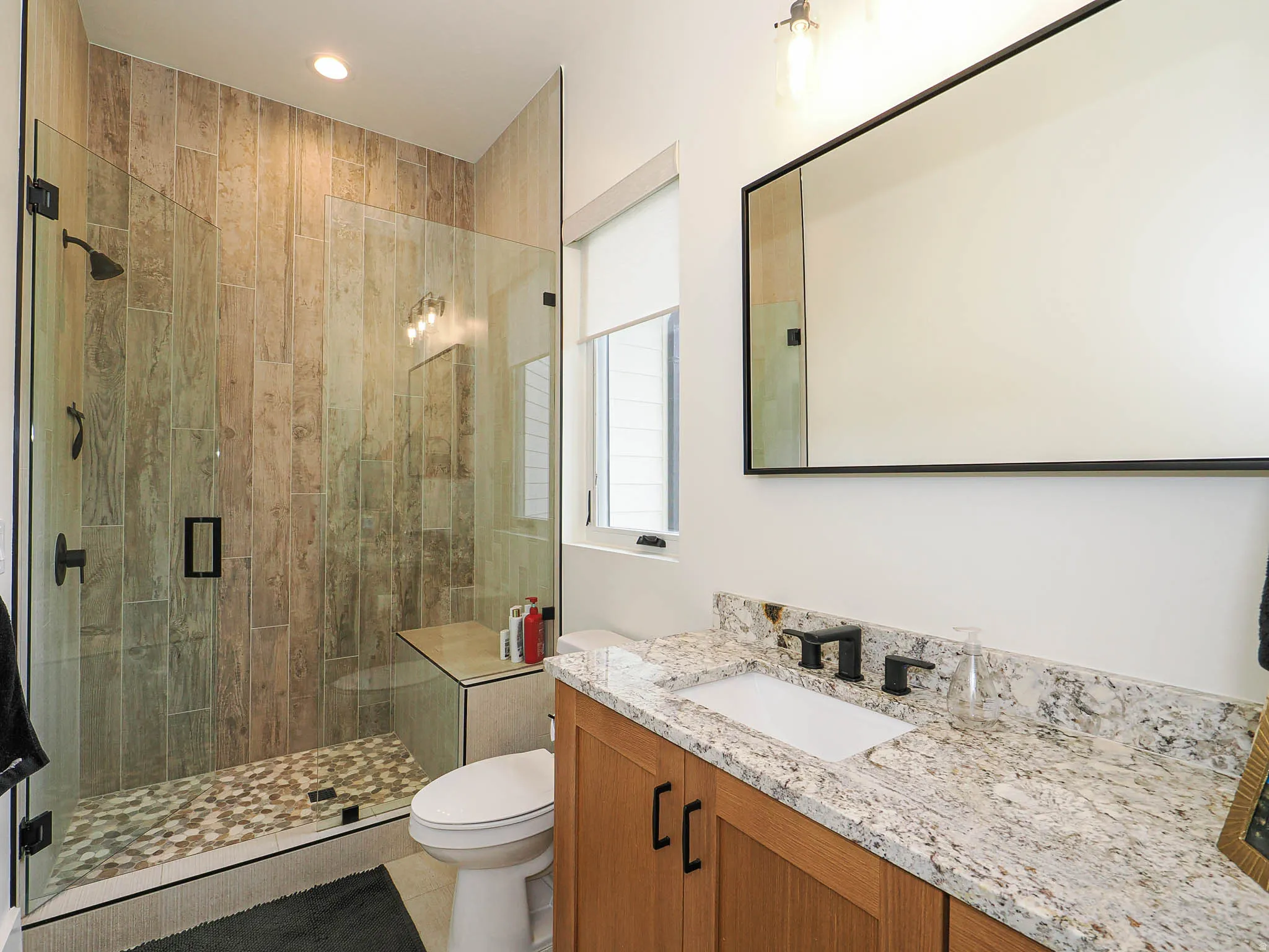Bathroom with vanity, a shower stall, light tile patterned floors, and recessed lighting