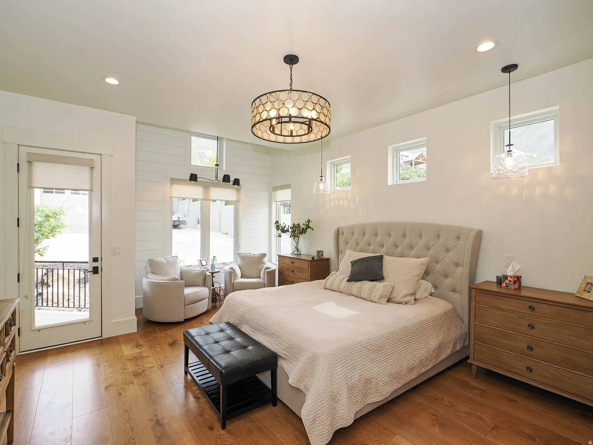 Bedroom featuring hardwood / wood-style flooring, recessed lighting, wooden walls, and access to exterior