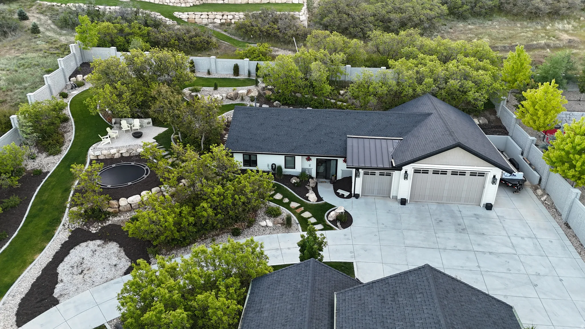 Contemporary exterior with a dark shingle roof and a multi-car garage, featuring a concrete driveway