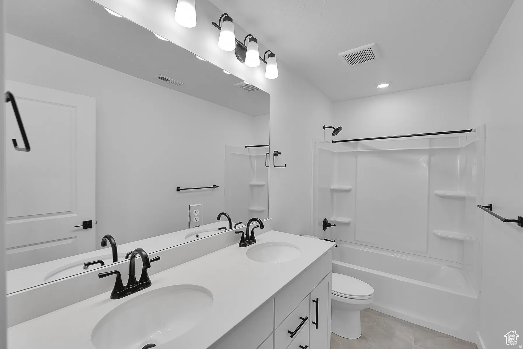 *Colors may vary** Full bath with double vanity, shower / bathtub combination, and recessed lighting