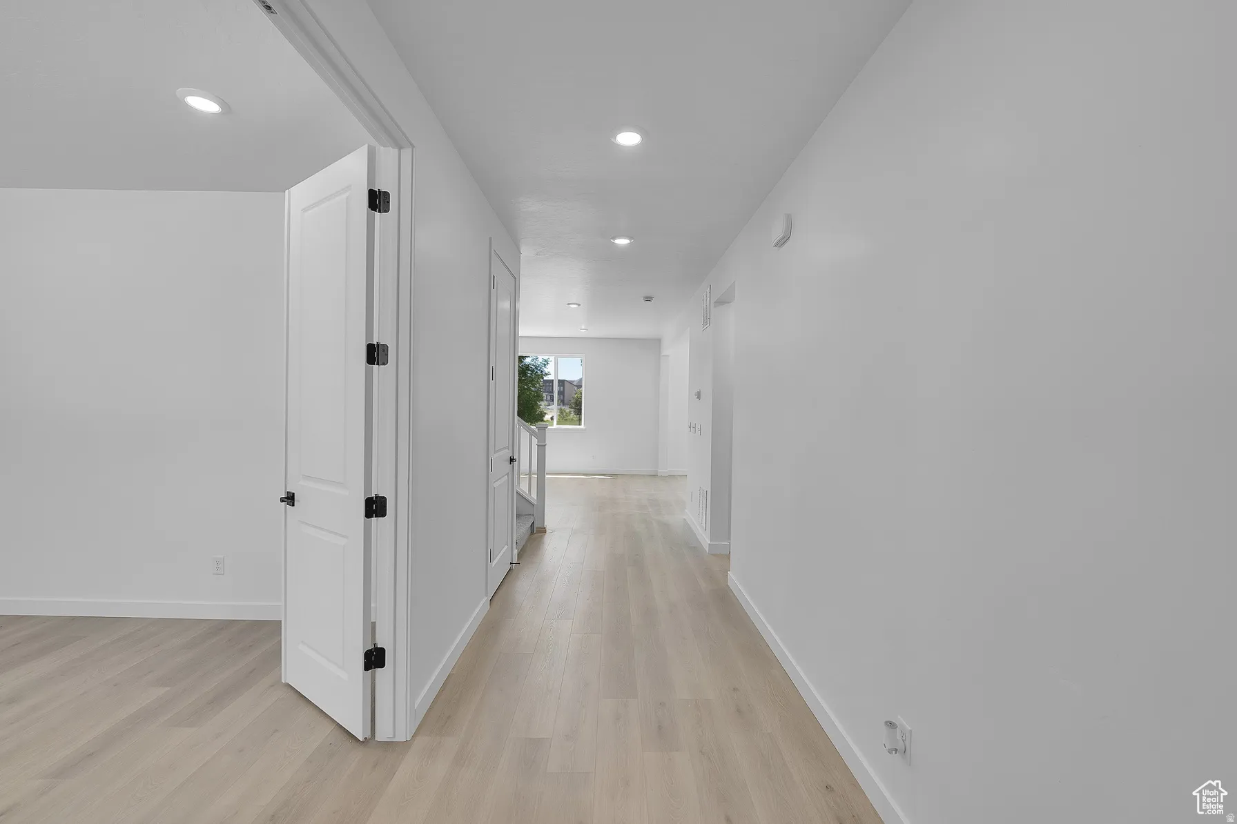 *Colors may vary** Corridor with light wood-style floors and recessed lighting