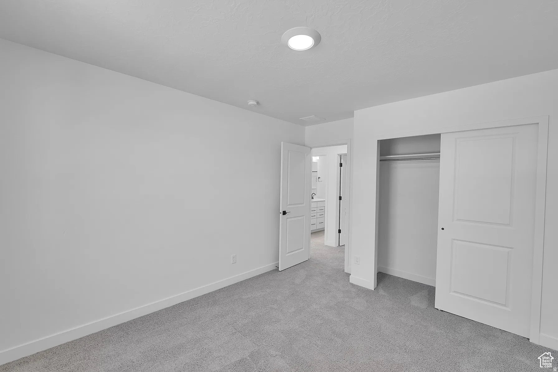 *Colors may vary** Unfurnished bedroom with light carpet and a closet